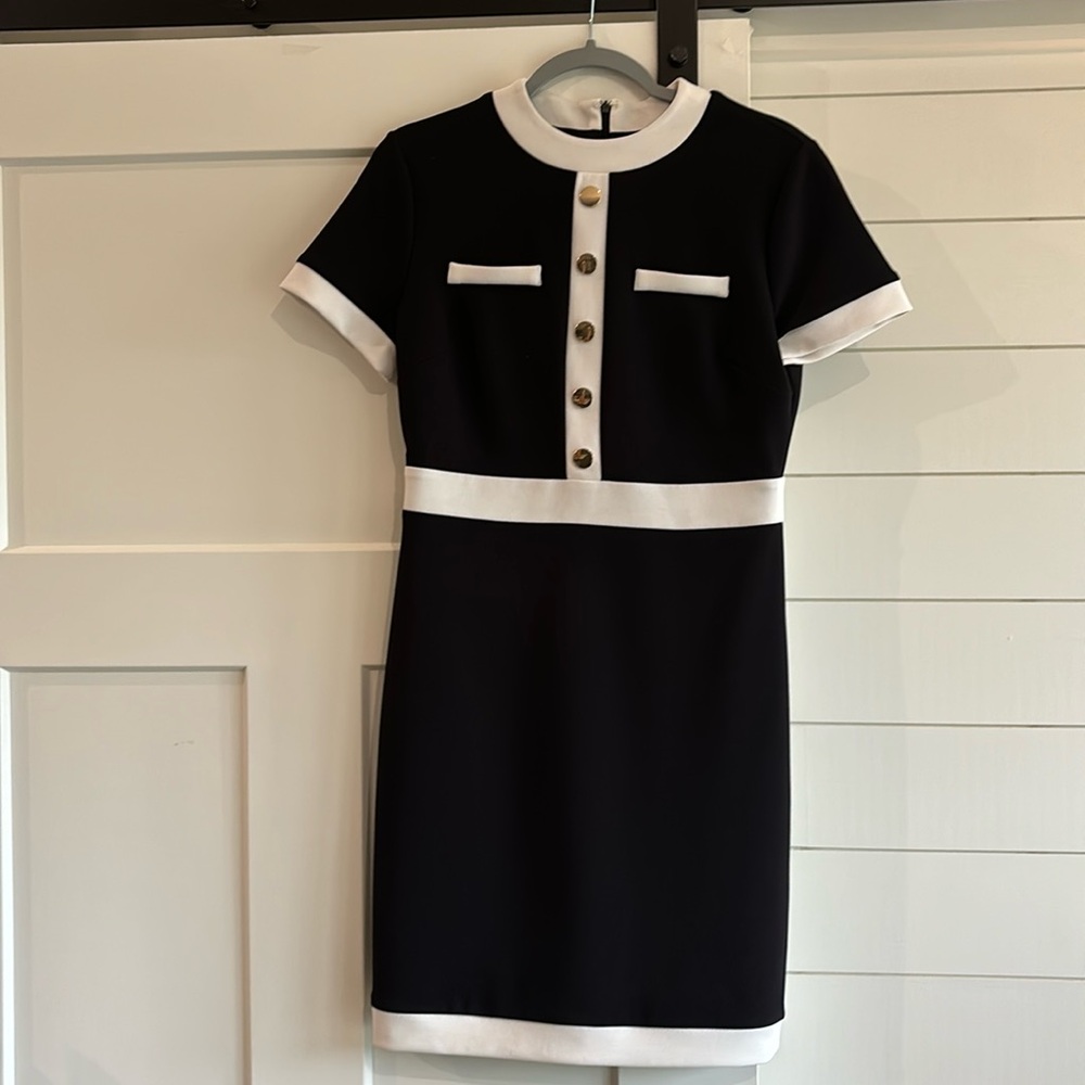 Black and White knee length dress with gold faux buttons. Back zip. Lined.